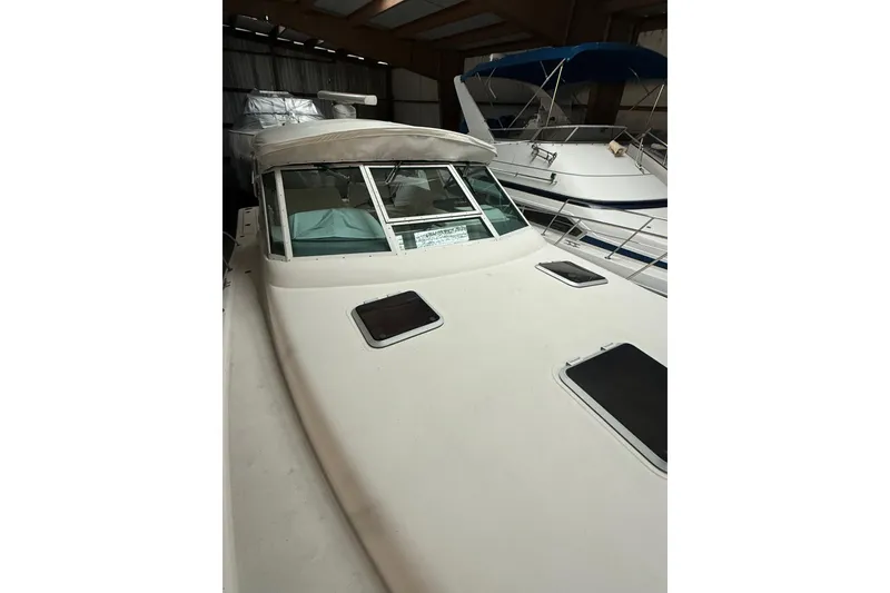 Slide: The Image of 1998 Tiara Yachts 3500 Open boat in storage, showcasing sleek design and spacious deck. - 5