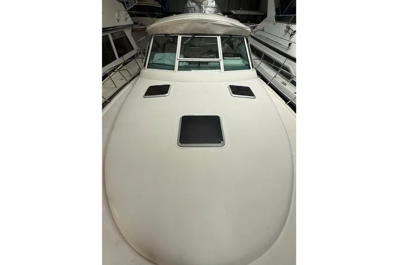 Slide: The Image of 1998 Tiara Yachts 3500 Open boat deck with hatches, docked indoors. - 6