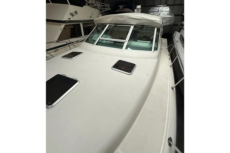 Slide: The Image of 1998 Tiara Yachts 3500 Open boat in storage, showcasing deck and windows. - 7