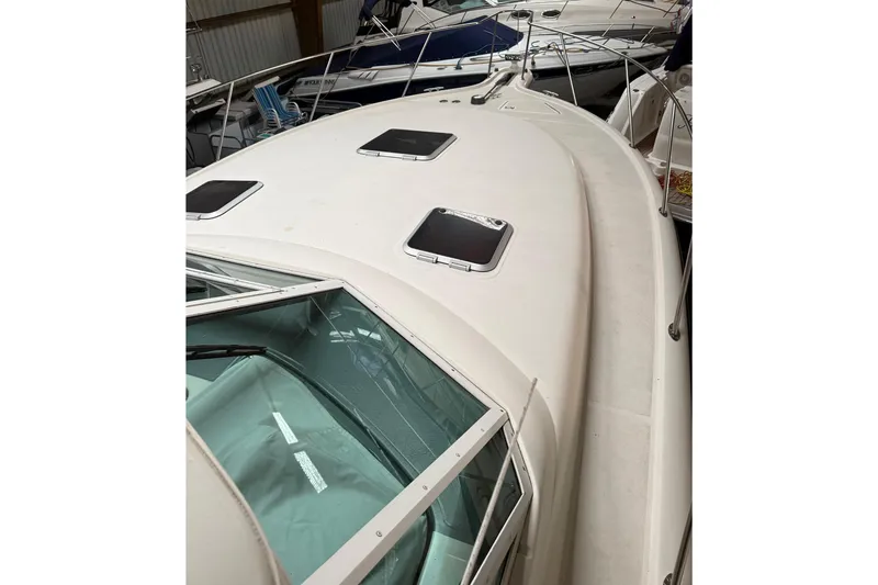 Slide: The Image of 1998 Tiara Yachts 3500 Open boat deck with hatches, docked indoors. - 8