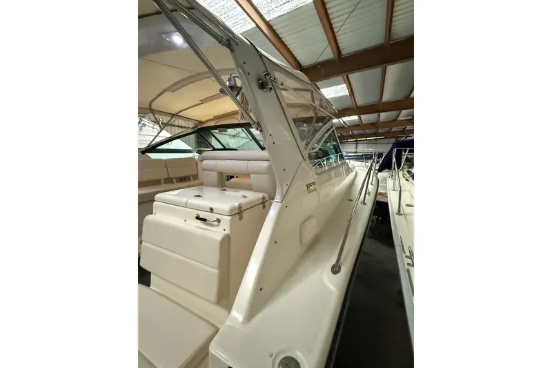 Slide: The Image of 1998 Tiara Yachts 3500 Open, interior view, showcasing seating and helm under covered storage. - 9