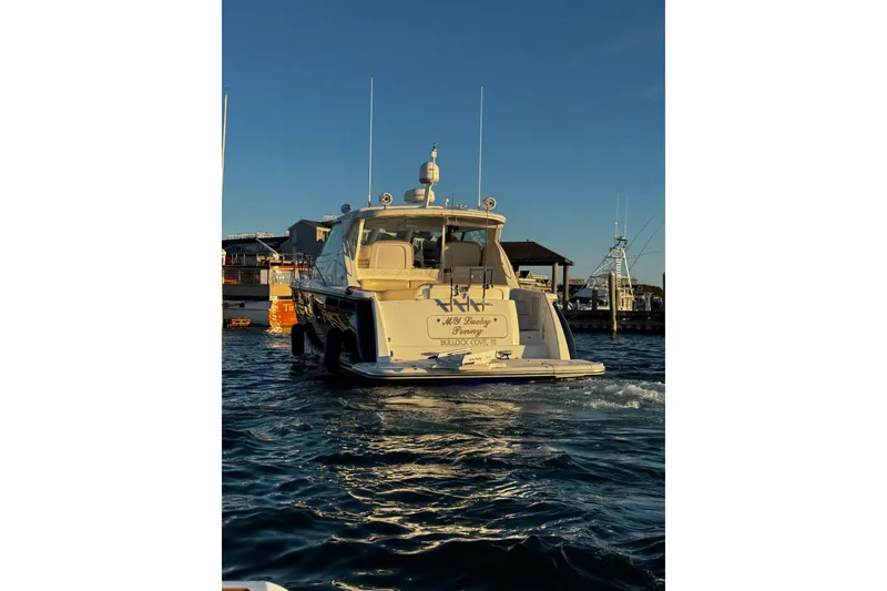 Slide: The Image of 2006 Tiara Yachts 4300 Sovran on water near docks at sunset. - 11