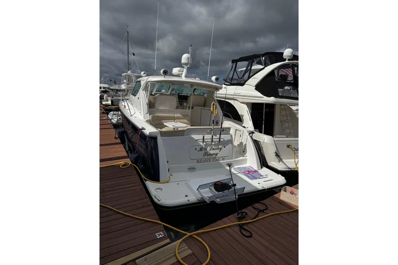 Slide: The Image of 2006 Tiara Yachts 4300 Sovran docked at marina under cloudy skies. - 13