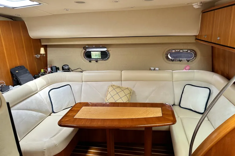 Slide: The Image of Luxurious interior of 2006 Tiara Yachts 4300 Sovran with elegant seating and wooden table. - 16