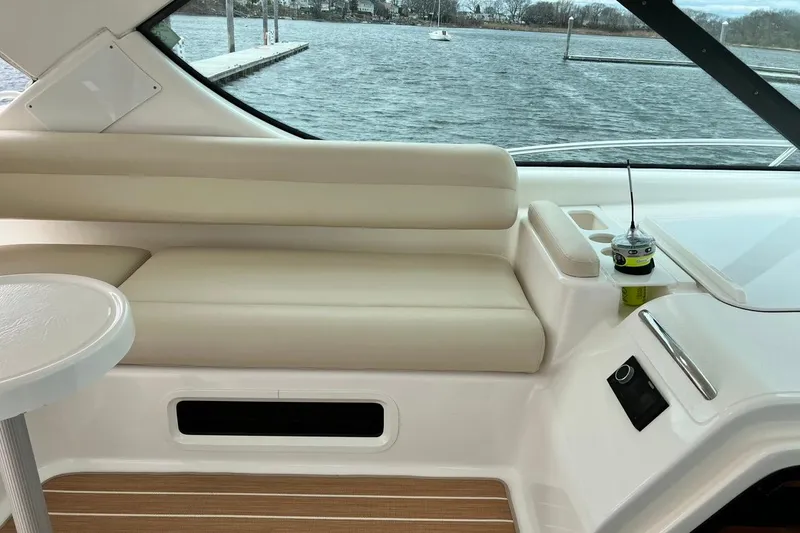 Slide: The Image of Interior of 2006 Tiara Yachts 4300 Sovran with beige seating and scenic water view. - 23