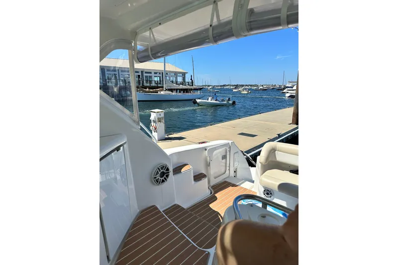 Slide: The Image of 2006 Tiara Yachts 4300 Sovran at marina, showcasing deck and waterfront view. - 25