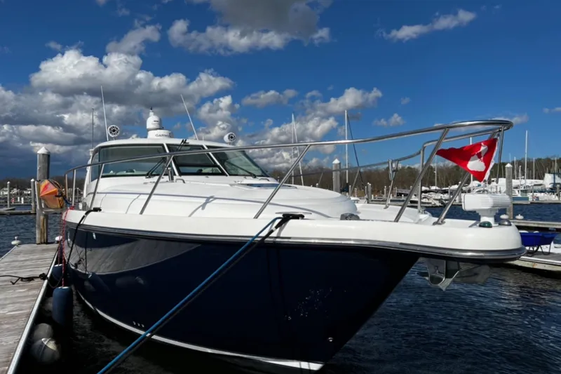 Slide: The Image of 2006 Tiara Yachts 4300 Sovran docked under a blue sky with clouds. - 3