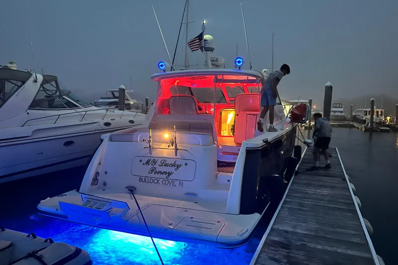Slide: The Image of 2006 Tiara Yachts 4300 Sovran docked at night with blue underwater lights. - 6