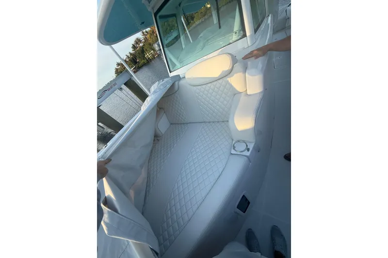 Slide: The Image of Luxurious seating on 2022 HCB 42 Lujo boat with quilted upholstery and cup holder. - 10