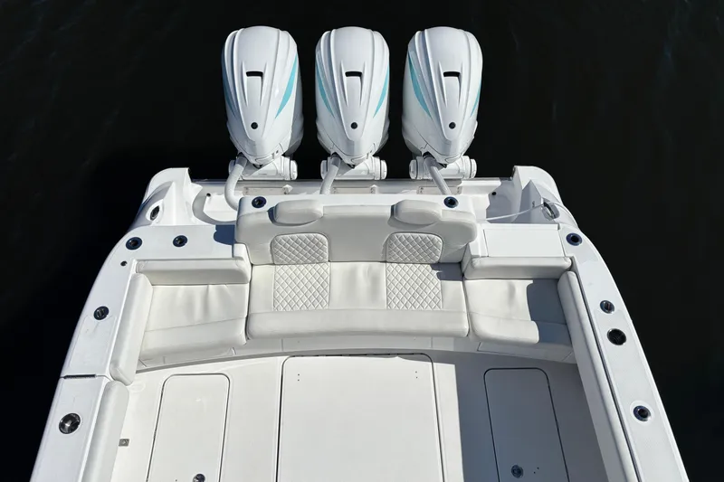 Slide: The Image of 2022 HCB 42 Lujo boat with triple outboard engines and luxurious seating. - 4