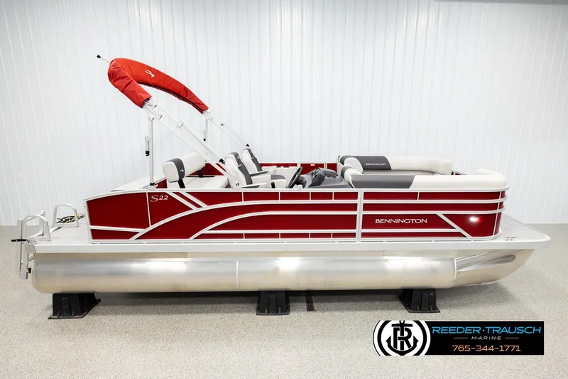 Slide: The Image of 2026 Bennington SSBSF pontoon boat with red and white design, displayed indoors. - 1