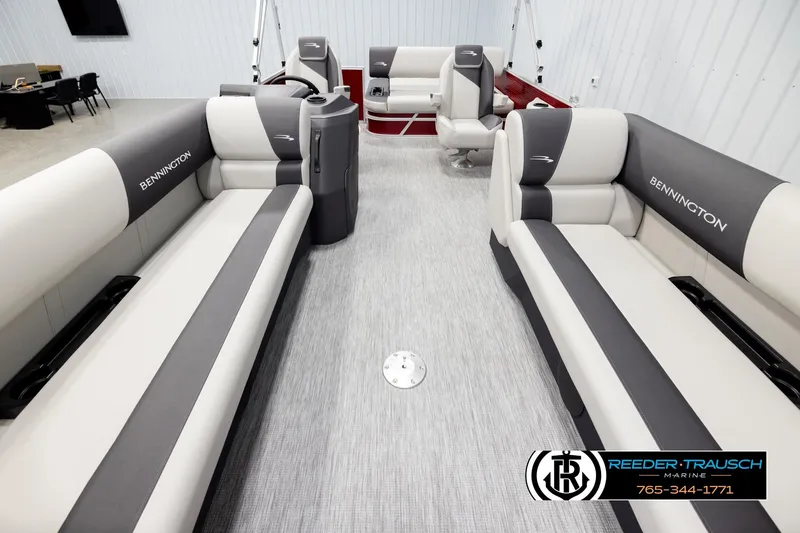 Slide: The Image of 2026 Bennington SSBSF boat interior with gray and white seating, showcased by Reeder-Trausch Marine. - 13