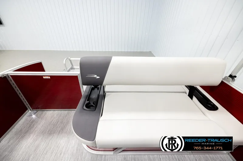 Slide: The Image of 2026 Bennington SSBSF boat seat with cup holders, red paneling, and Reeder Trausch Marine logo. - 15