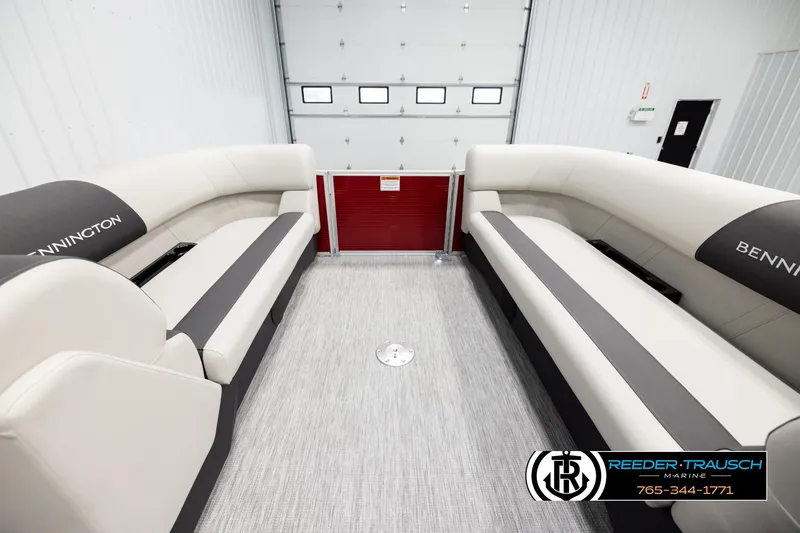 Slide: The Image of 2026 Bennington SSBSF boat interior with beige seating and gray accents in a showroom. - 18
