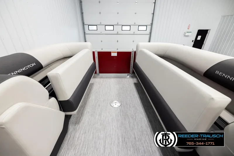 Slide: The Image of 2026 Bennington SSBSF boat interior with plush seating in a showroom. - 20