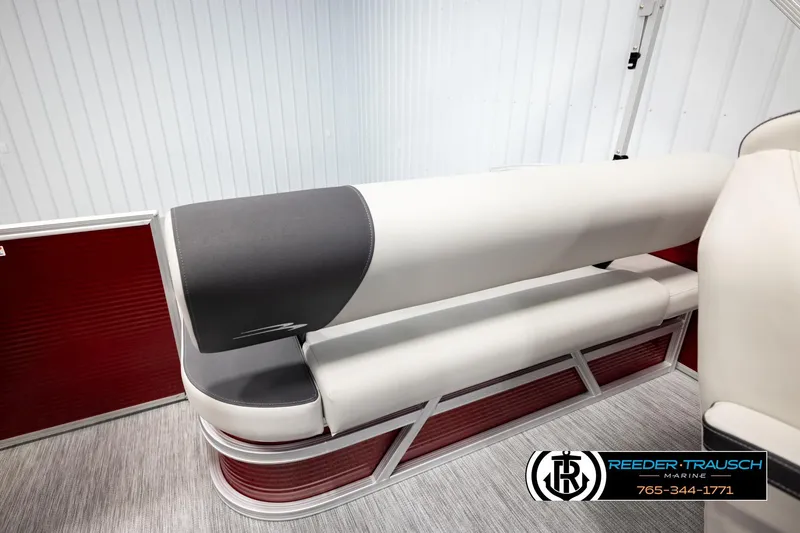 Slide: The Image of 2026 Bennington SSBSF boat interior with red and white seating, Reeder-Trausch Marine logo. - 23