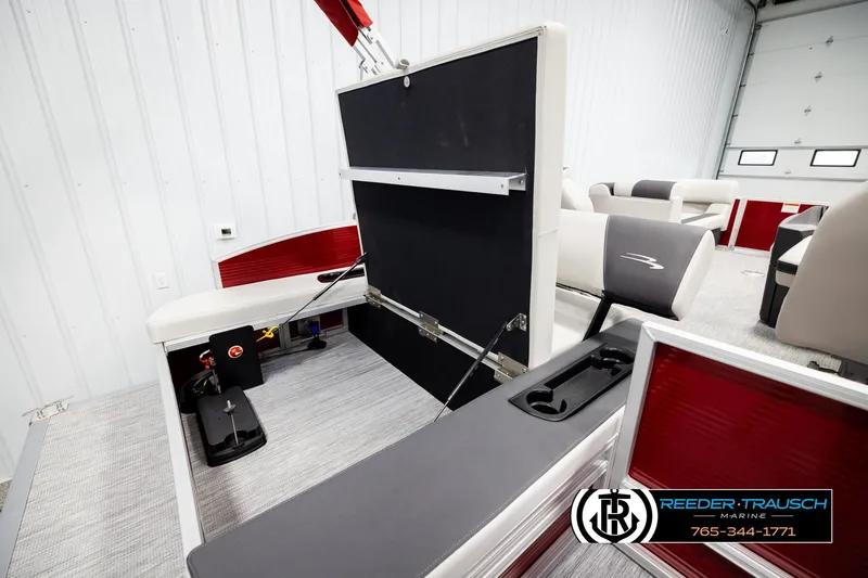 Slide: The Image of 2026 Bennington SSBSF boat interior with seating and storage compartments in a showroom. - 27