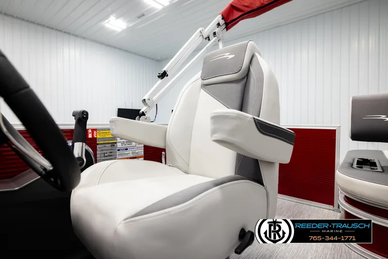 Slide: The Image of 2026 Bennington SSBSF boat interior with white and gray seating, steering wheel, and red accents. - 28