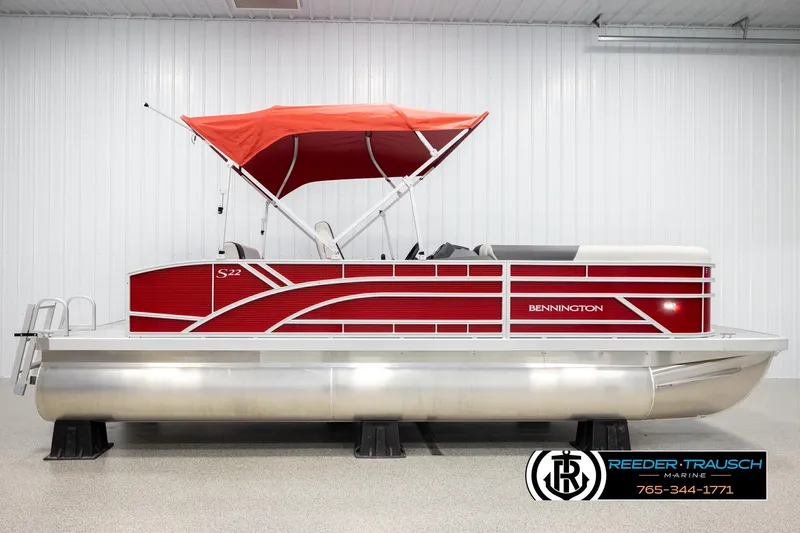 Slide: The Image of 2026 Bennington SSBSF pontoon boat with red canopy in showroom. - 5