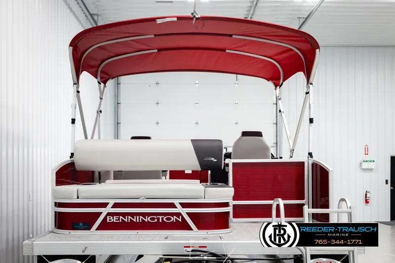 Slide: The Image of 2026 Bennington SSBSF pontoon boat with red canopy in showroom. - 7