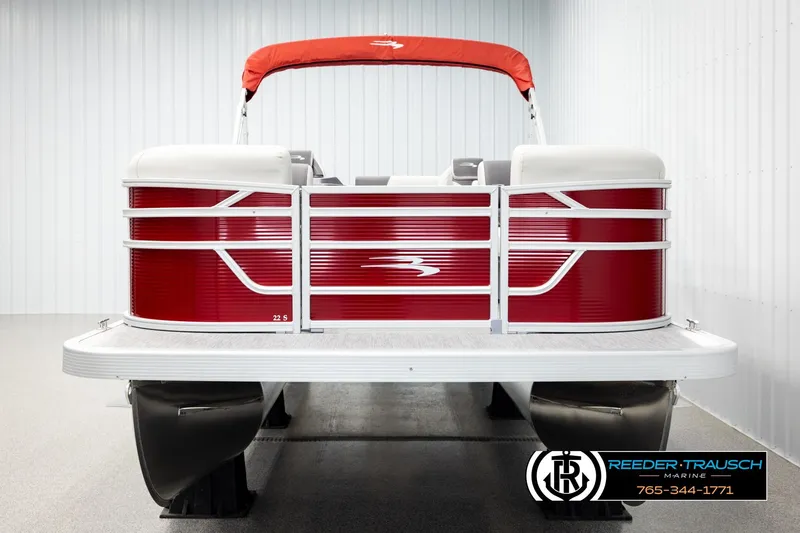 Slide: The Image of 2026 Bennington SSBSF pontoon boat with red and white design in showroom. - 8