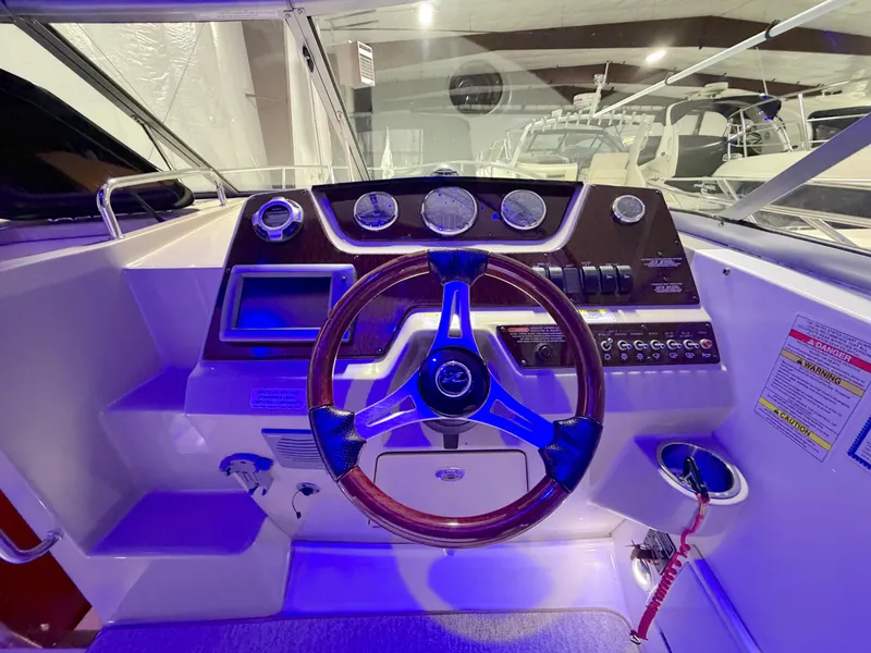 Slide: The Image of Cockpit of 2012 Sea Ray Sundancer 280 with wooden steering wheel. - 11