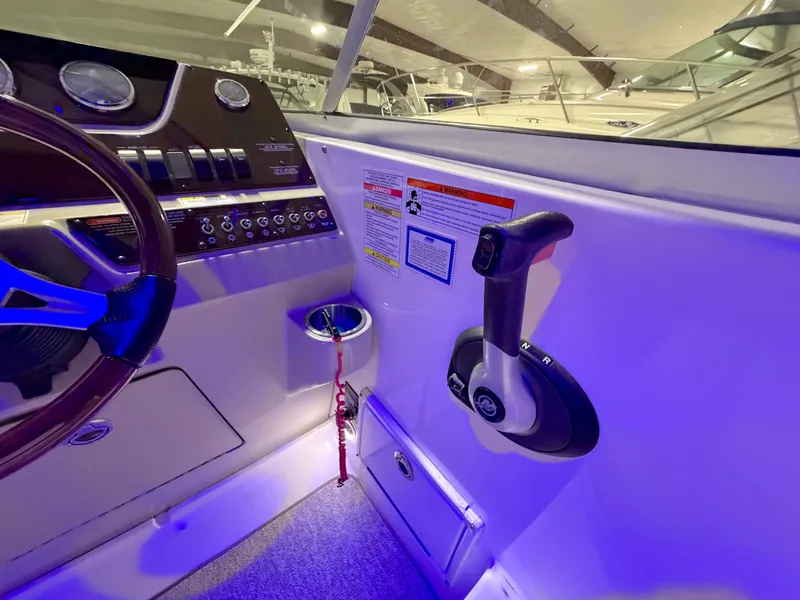 Slide: The Image of Sea Ray Sundancer 280 helm, 2012 model, featuring blue ambient lighting. - 12