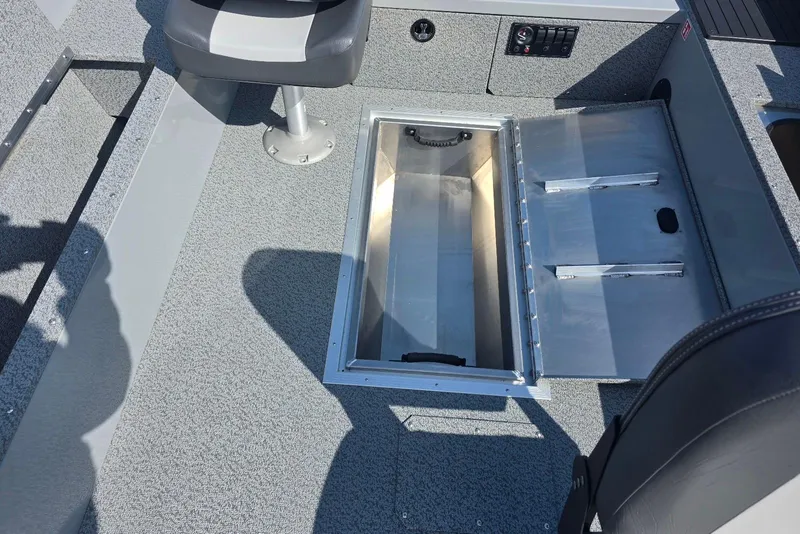 Slide: The Image of 2026 Smoker Craft Freedom 160 TL boat interior with open storage compartment. - 15