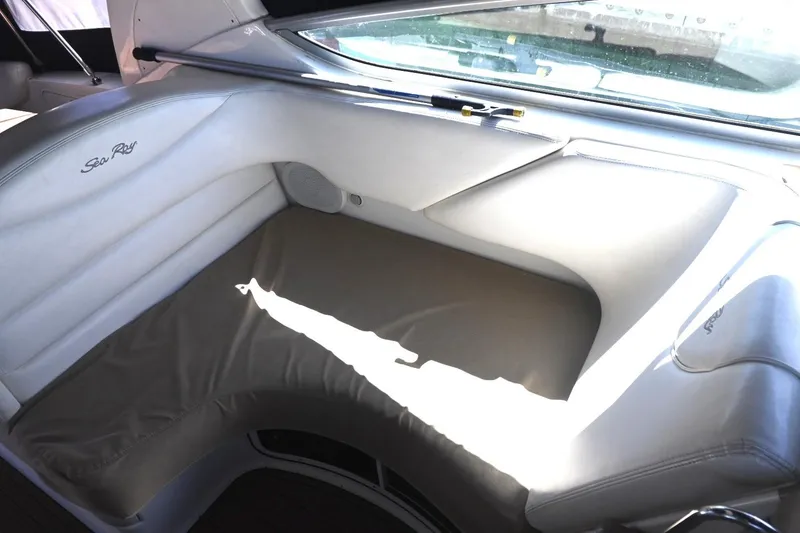 Slide: The Image of Interior seating of a 2005 Sea Ray Sundancer 280 boat, featuring white upholstery. - 10
