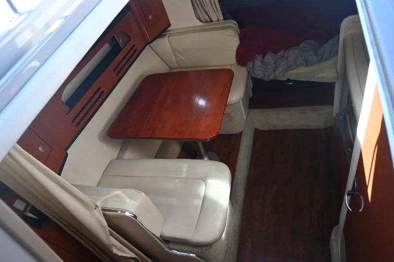 Slide: The Image of 2005 Sea Ray Sundancer 280 cabin interior with dining area and seating. - 15