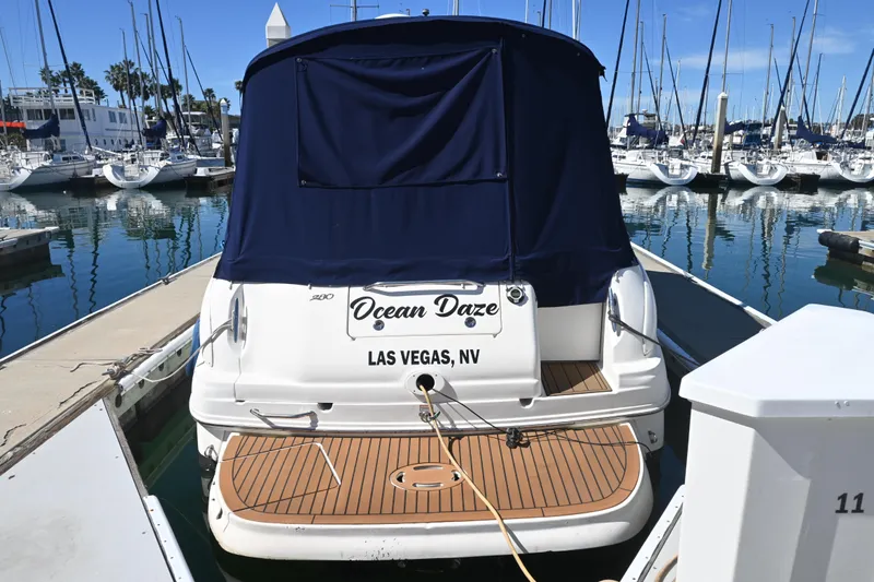 Slide: The Image of 2005 Sea Ray Sundancer 280 docked at marina, rear view with blue cover. - 2