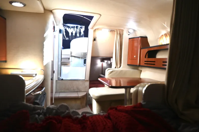 Slide: The Image of Interior of 2005 Sea Ray Sundancer 280, featuring cozy seating and elegant wood finishes. - 21