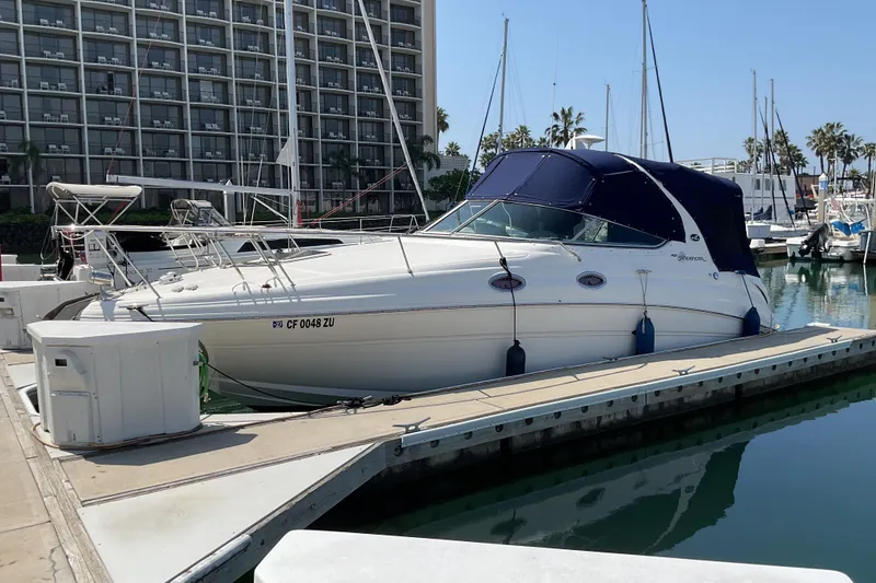 Slide: The Image of 2005 Sea Ray Sundancer 280 docked at marina with blue canopy. - 33
