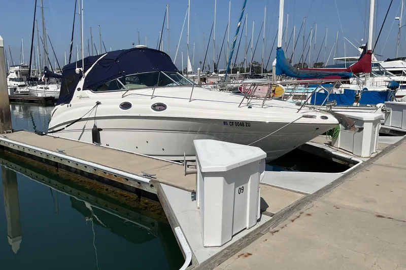 Slide: The Image of 2005 Sea Ray Sundancer 280 docked at marina with sailboats in background. - 34