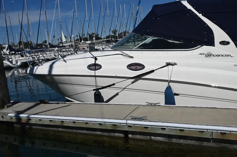 Slide: The Image of 2005 Sea Ray Sundancer 280 docked at marina with sailboats in background. - 5