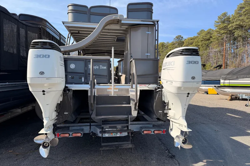 Slide: The Image of 2022 Premier 350 Escalante pontoon boat with dual Suzuki 300 outboard motors. - 2