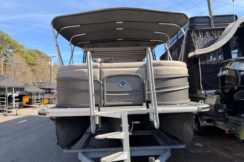 Slide: The Image of 2022 Premier 350 Escalante pontoon boat on trailer, outdoor display. - 22