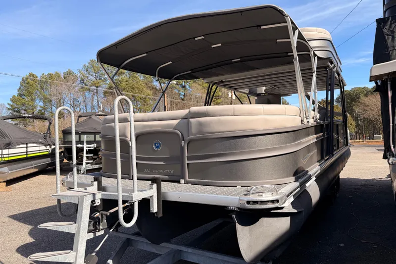 Slide: The Image of 2022 Premier 350 Escalante pontoon boat with canopy, parked outdoors. - 24