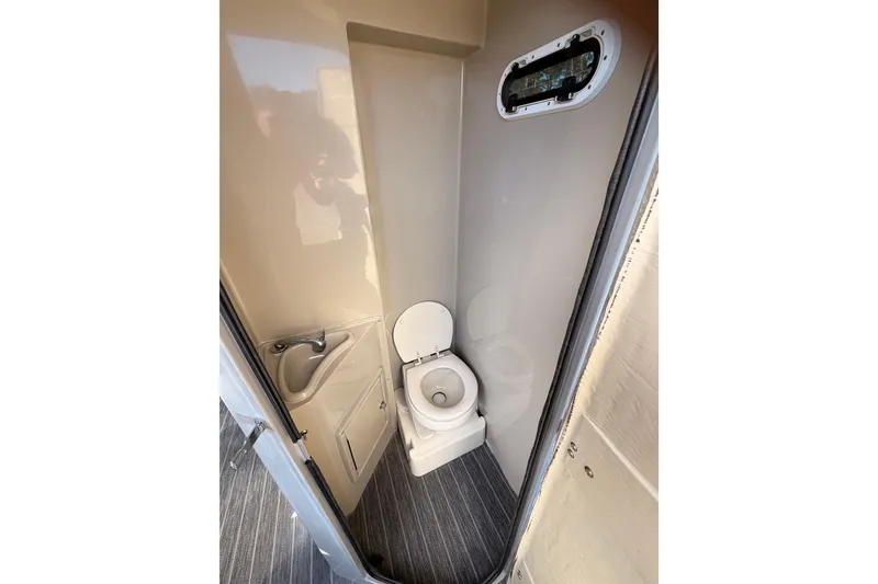 Slide: The Image of Compact bathroom in 2022 Premier 350 Escalante, featuring toilet, sink, and small window. - 6