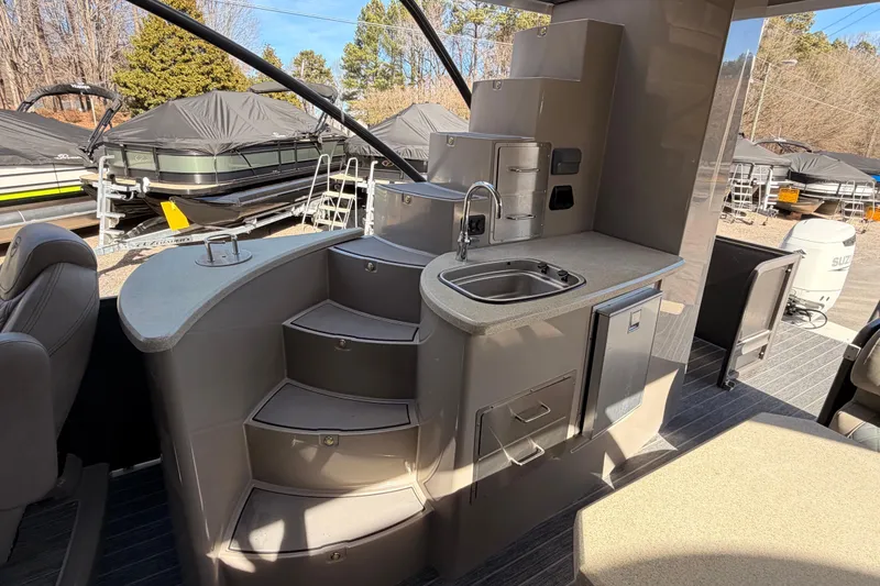 Slide: The Image of 2022 Premier 350 Escalante boat interior with kitchenette and stairs, showcasing modern design. - 9