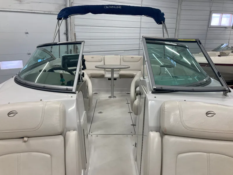 Slide: The Image of Interior view of a 2009 Crownline 240LS Bowrider boat in a garage. - 12