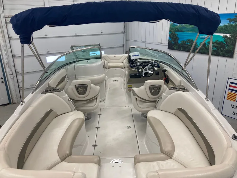 Slide: The Image of Interior of a 2009 Crownline 240LS Bowrider with blue canopy. - 17