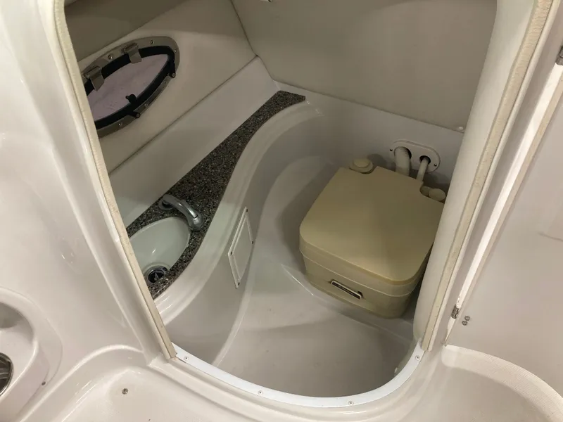 Slide: The Image of Interior of 2009 Crownline 240LS Bowrider with toilet and sink. - 25