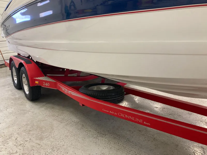 Slide: The Image of 2009 Crownline 240LS Bowrider on red trailer in garage. - 31