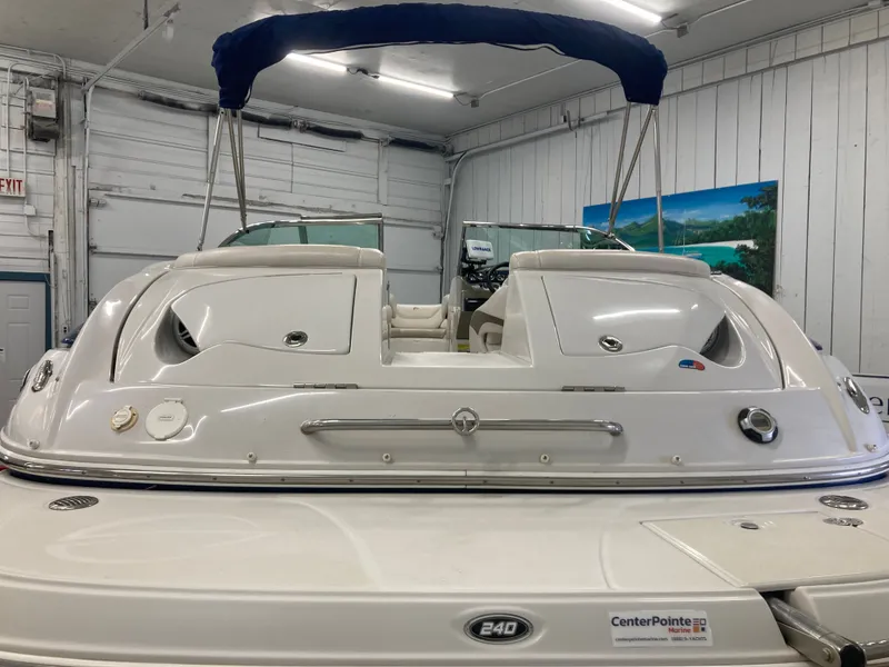 Slide: The Image of 2009 Crownline 240LS Bowrider indoors with blue cover. - 5