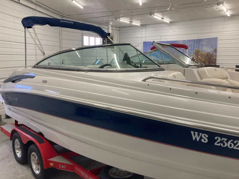 Slide: The Image of 2009 Crownline 240LS Bowrider on red trailer in garage. - 8