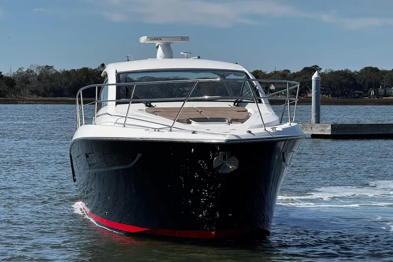Slide: The Image of 2014 Pursuit SC 365i Sport Coupe cruising on a calm waterway. - 1