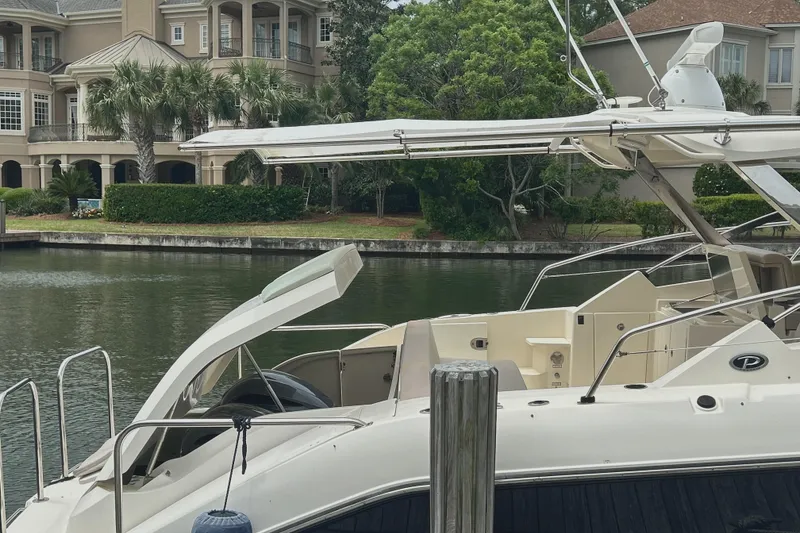 Slide: The Image of 2014 Pursuit SC 365i Sport Coupe docked near waterfront homes. - 14