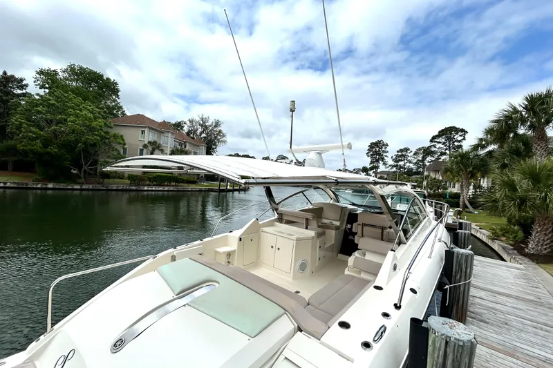 Slide: The Image of 2014 Pursuit SC 365i Sport Coupe docked by a scenic waterfront. - 15