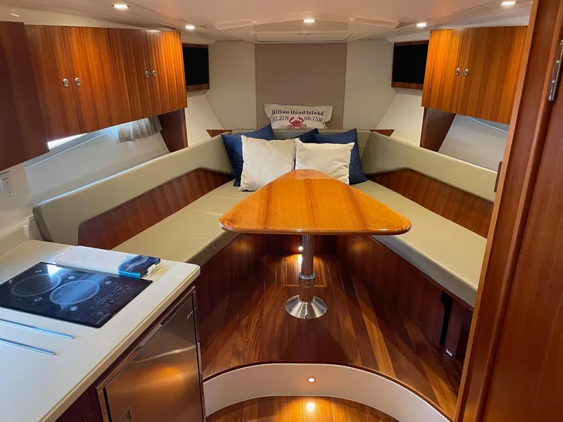 Slide: The Image of Luxurious interior of 2014 Pursuit SC 365i Sport Coupe with wood finishes and cozy seating. - 18